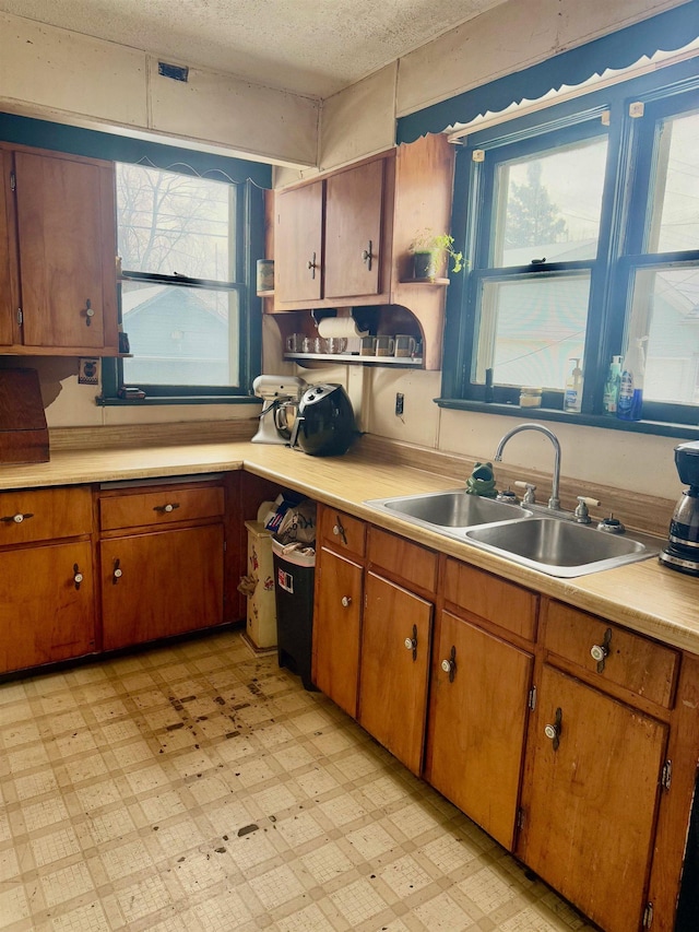 kitchen featuring sink and a textured ceiling