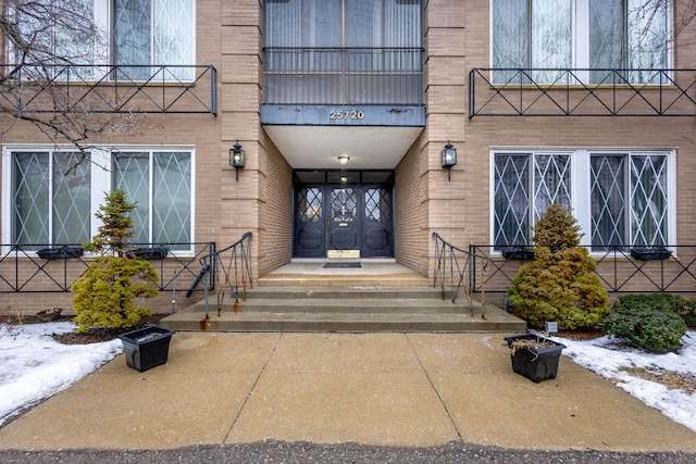 view of snow covered property entrance