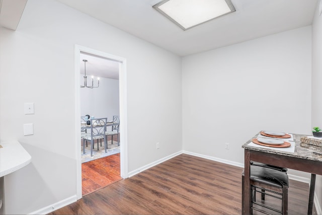 interior space with dark wood-type flooring and an inviting chandelier