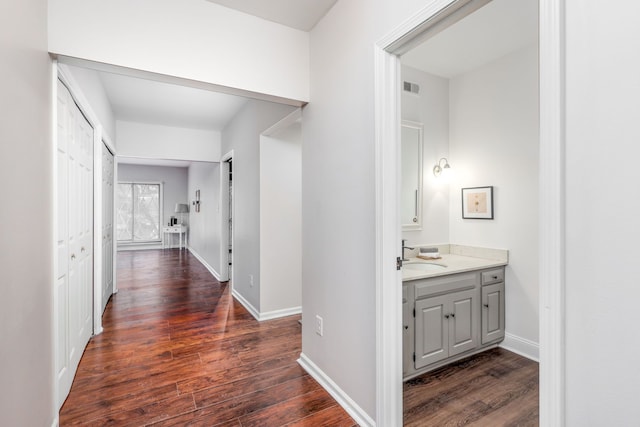 hall with sink and dark hardwood / wood-style floors