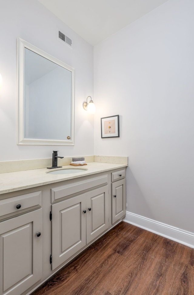 bathroom featuring hardwood / wood-style flooring and vanity