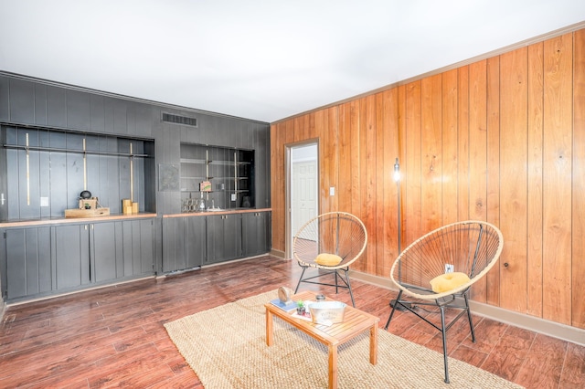 living room featuring wooden walls and hardwood / wood-style flooring