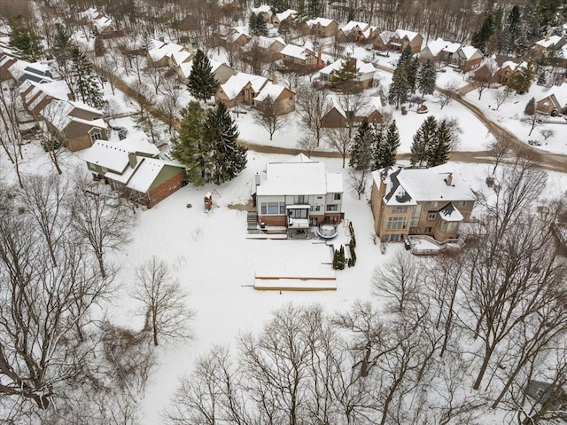 snowy aerial view with a residential view