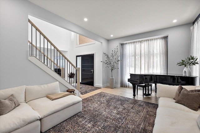 living area featuring stairs, baseboards, wood finished floors, and recessed lighting