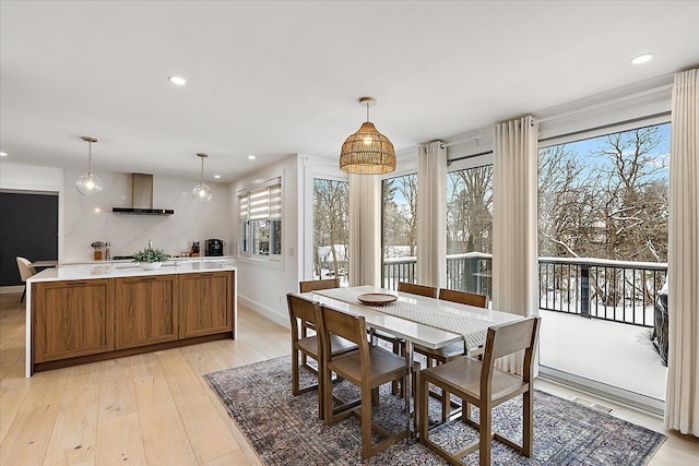 dining space with baseboards, light wood-type flooring, visible vents, and recessed lighting