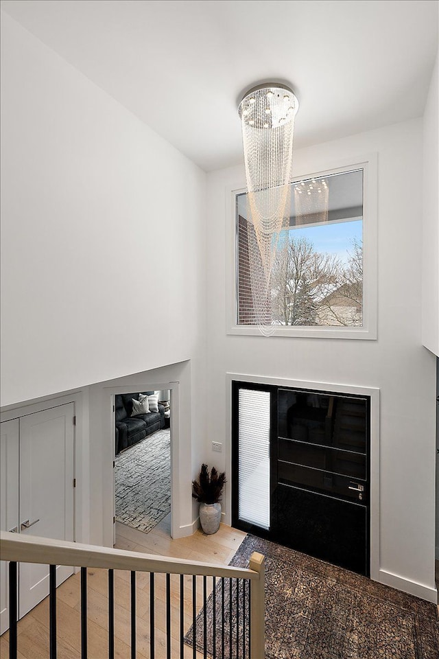 foyer featuring wood finished floors and a notable chandelier