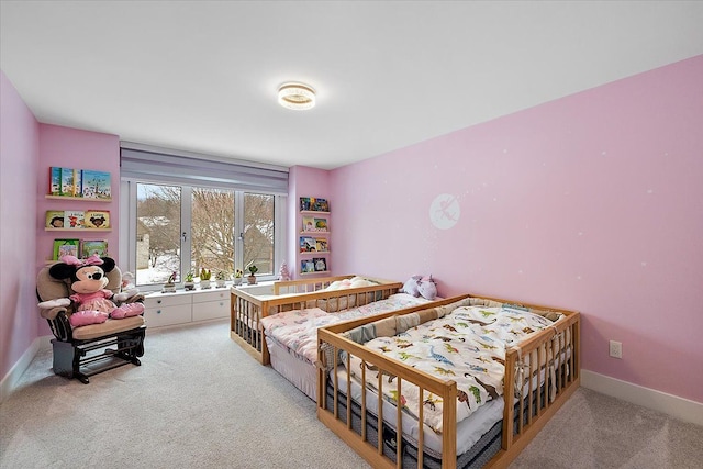 bedroom with light carpet and baseboards