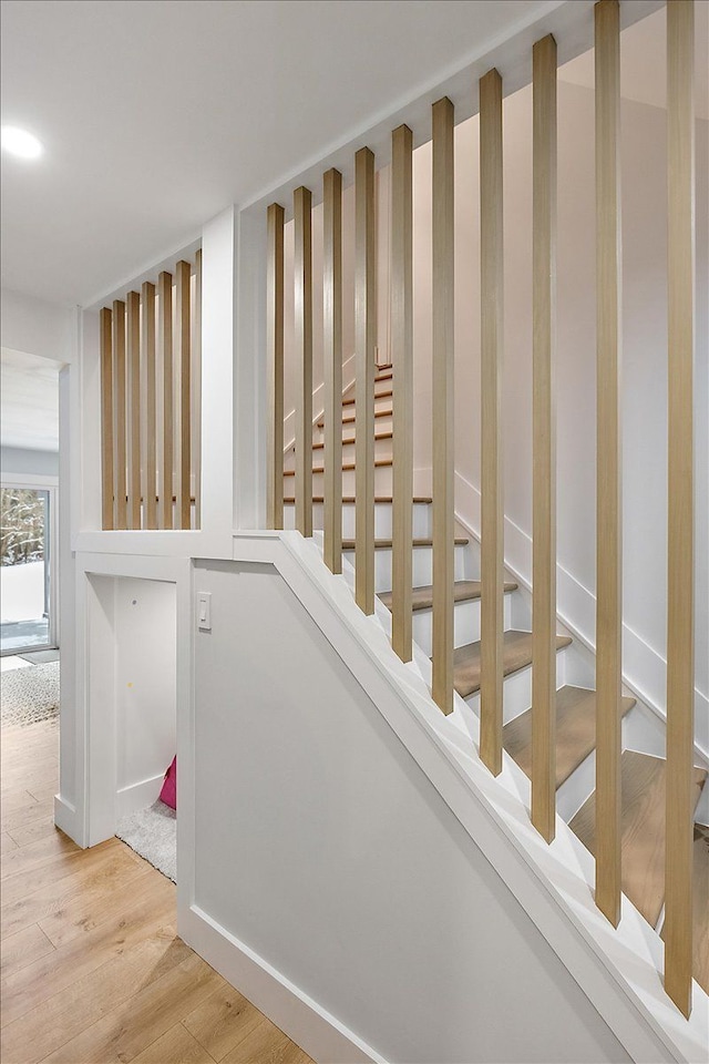 stairway with wood finished floors