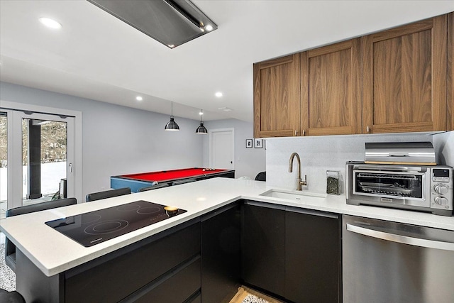 kitchen with black electric stovetop, a toaster, a sink, light countertops, and dishwasher