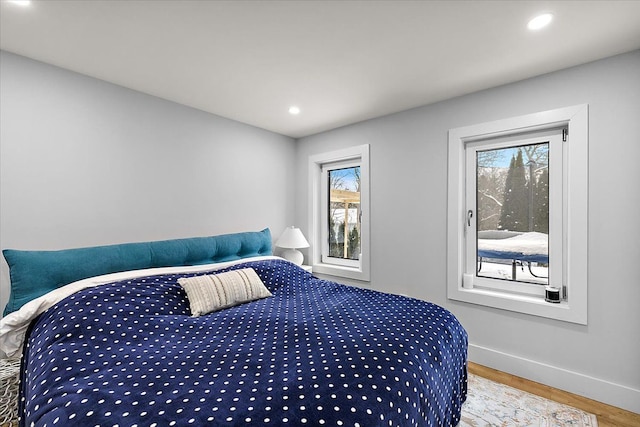 bedroom with recessed lighting, baseboards, and wood finished floors