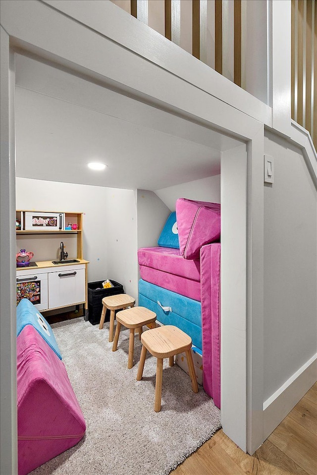 bedroom featuring light wood-type flooring and vaulted ceiling