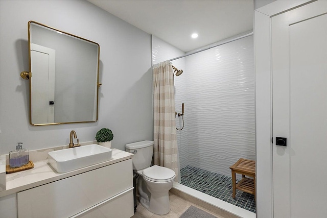 bathroom featuring toilet, a shower stall, and vanity