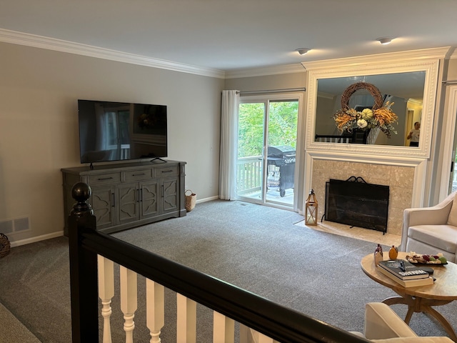 carpeted living room with crown molding and a tiled fireplace