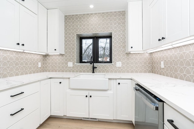 kitchen featuring sink, white cabinetry, and stainless steel dishwasher