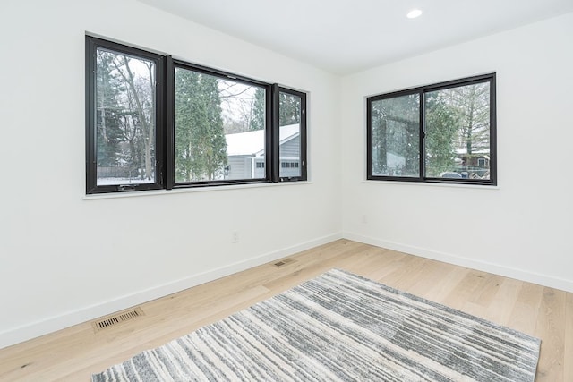 unfurnished room with hardwood / wood-style floors