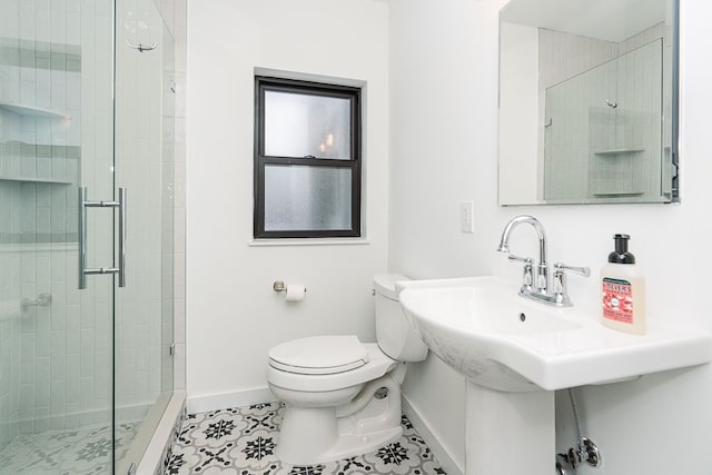 bathroom with a shower with door, toilet, and tile patterned floors