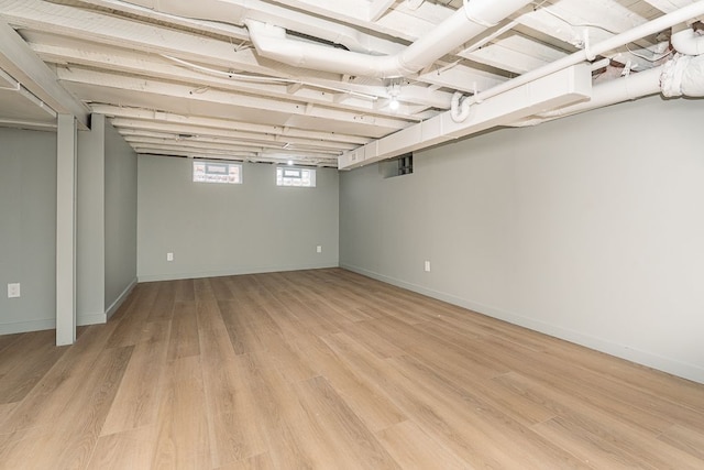 basement with light hardwood / wood-style floors