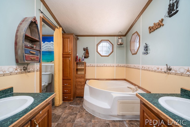 bathroom with a textured ceiling, toilet, vanity, and a tub to relax in