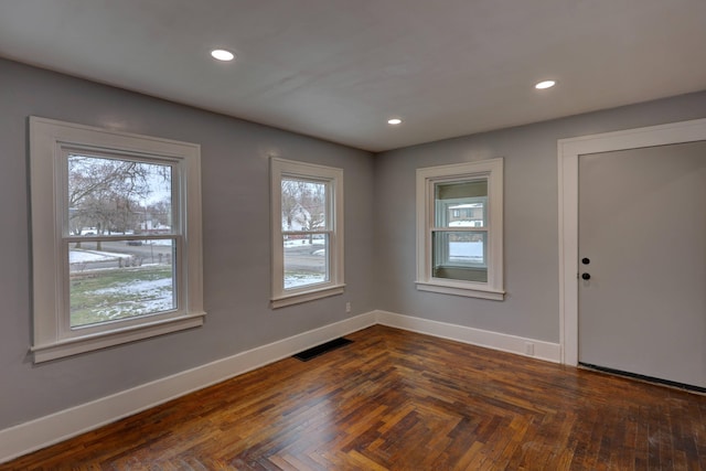 unfurnished room with dark parquet flooring