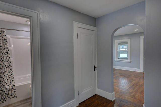 hallway with dark parquet flooring