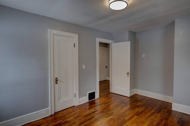 unfurnished bedroom featuring dark wood-type flooring