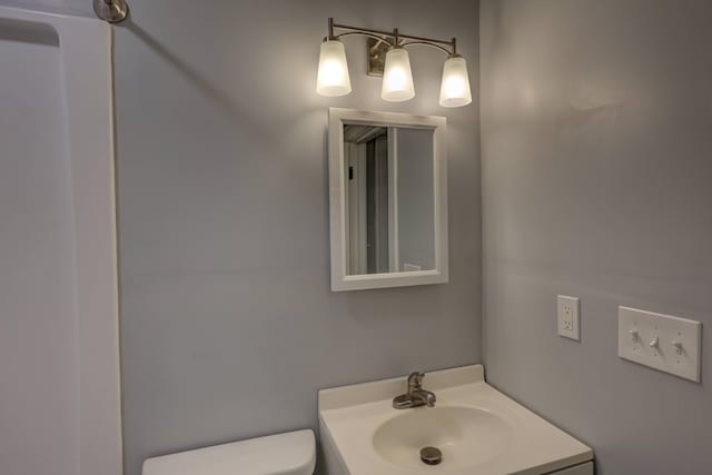 bathroom with toilet and vanity