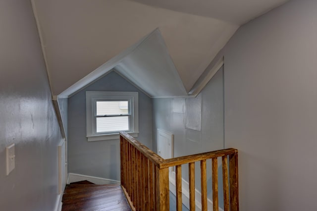 staircase with hardwood / wood-style flooring and lofted ceiling