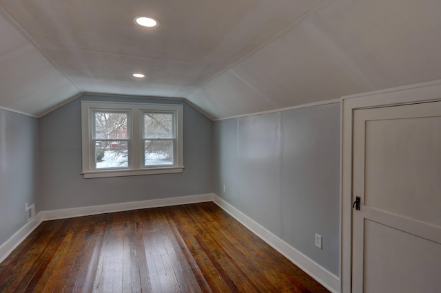 bonus room with dark wood-type flooring and lofted ceiling