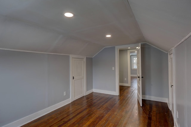 bonus room with dark hardwood / wood-style flooring and lofted ceiling