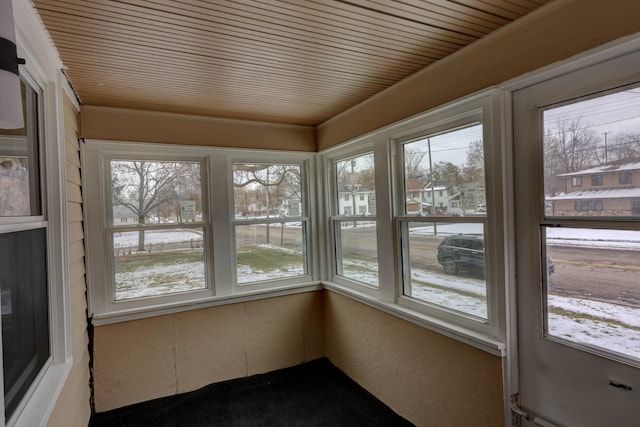 unfurnished sunroom with wooden ceiling