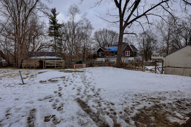 snowy yard featuring a trampoline