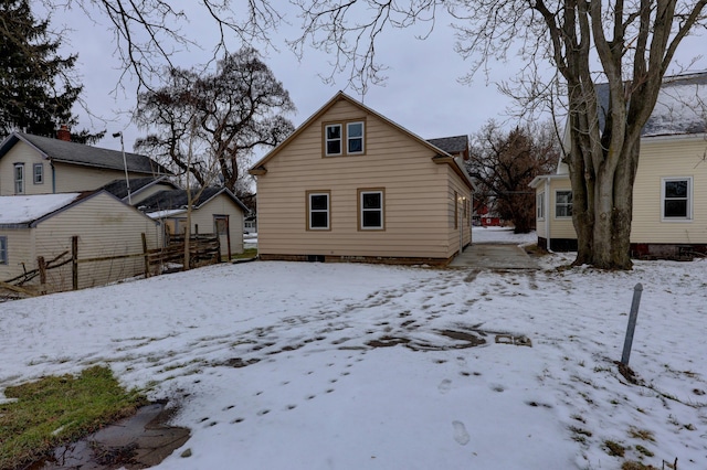 view of snow covered rear of property