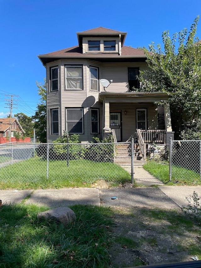 view of front of home with covered porch and a front lawn