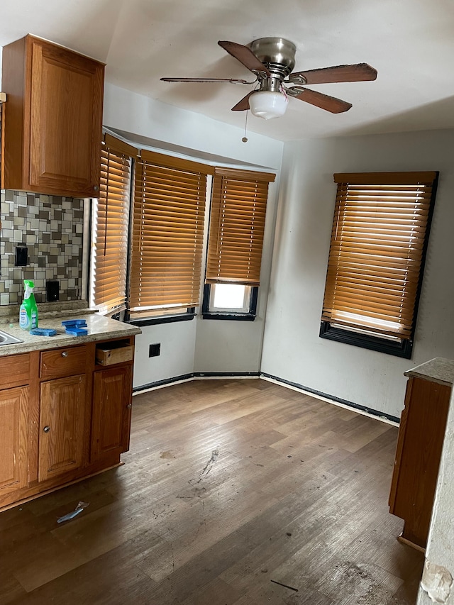 kitchen featuring ceiling fan, dark hardwood / wood-style floors, and tasteful backsplash