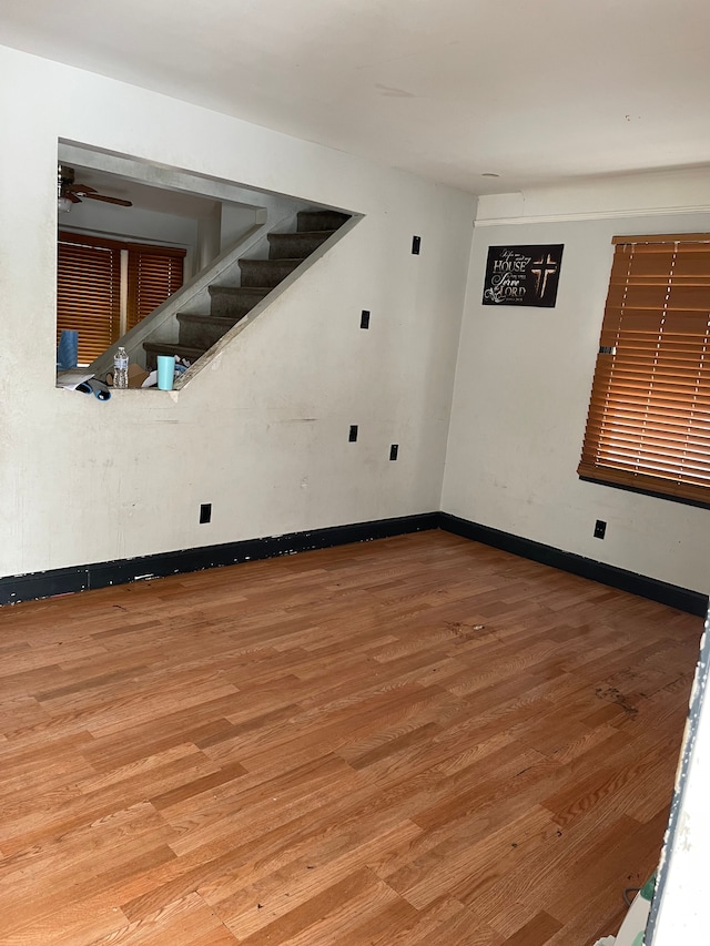 spare room with hardwood / wood-style flooring and ceiling fan