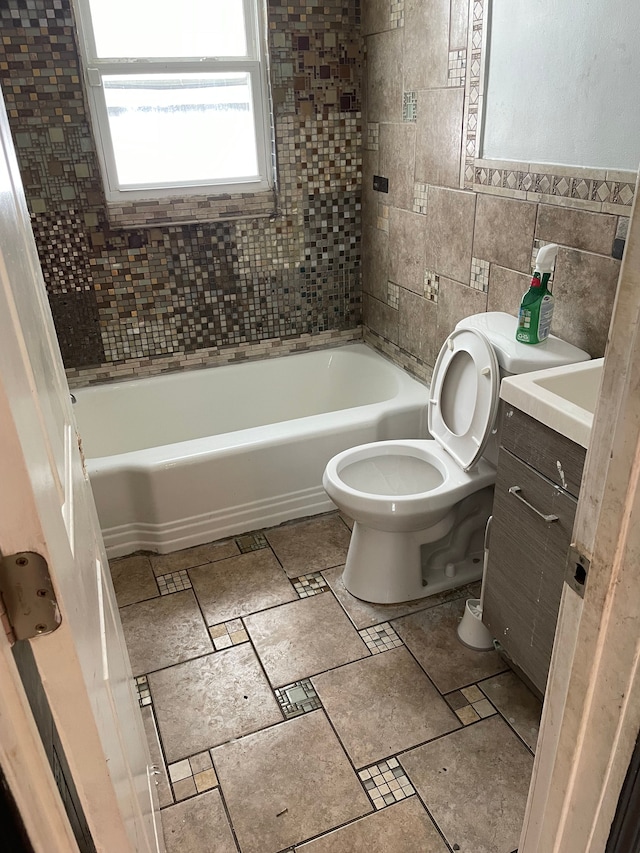 bathroom featuring toilet, tile walls, and vanity