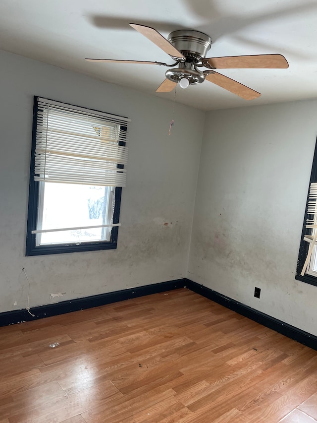 unfurnished room with ceiling fan and light wood-type flooring