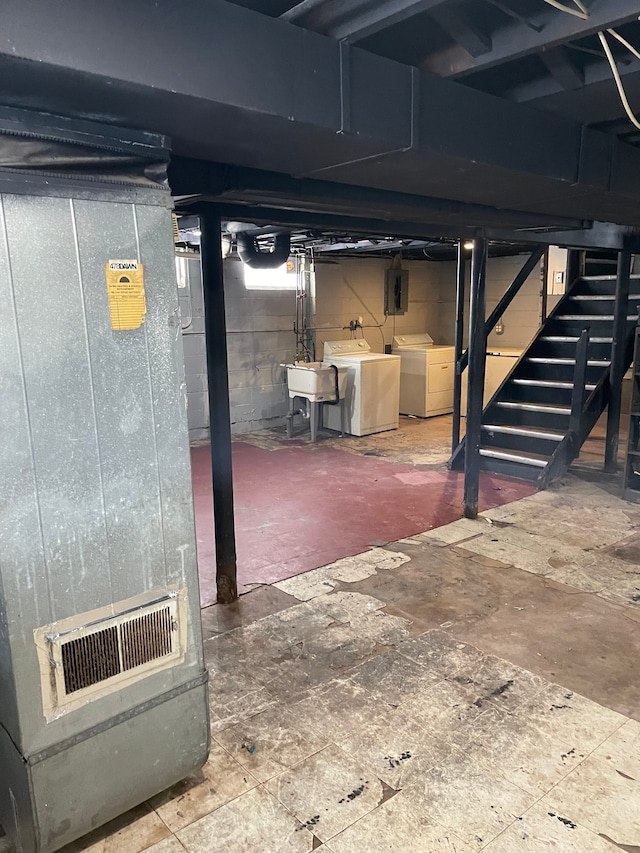 basement with washing machine and dryer and sink