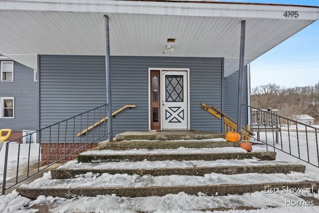 view of snow covered property entrance