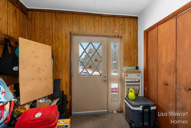 interior space with carpet and wood walls