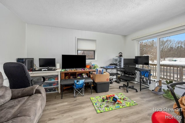 office area with a textured ceiling and light wood-type flooring