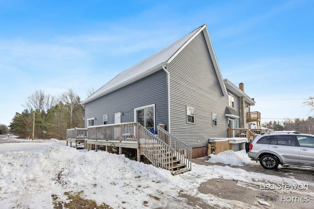 snow covered property featuring a deck