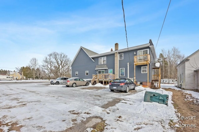 view of snow covered rear of property