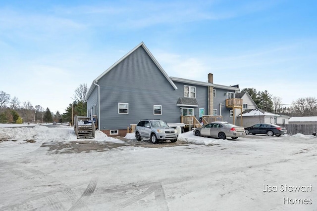 view of snow covered rear of property