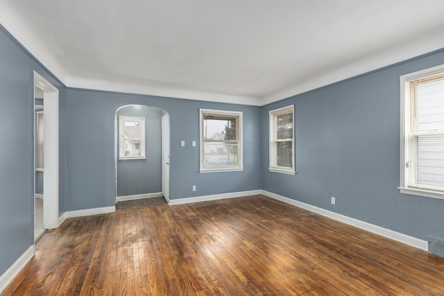 spare room with dark wood-type flooring