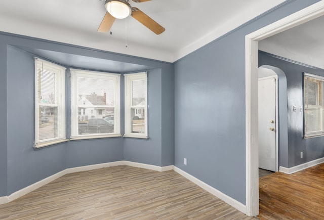 spare room with light hardwood / wood-style floors and ceiling fan