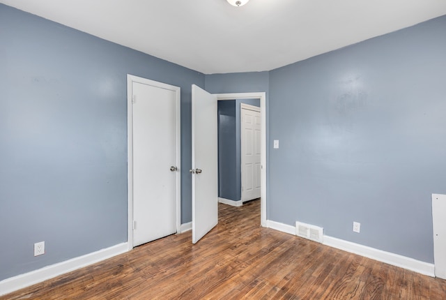 unfurnished room featuring dark hardwood / wood-style floors