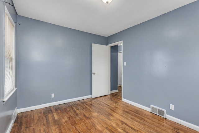 spare room featuring wood-type flooring