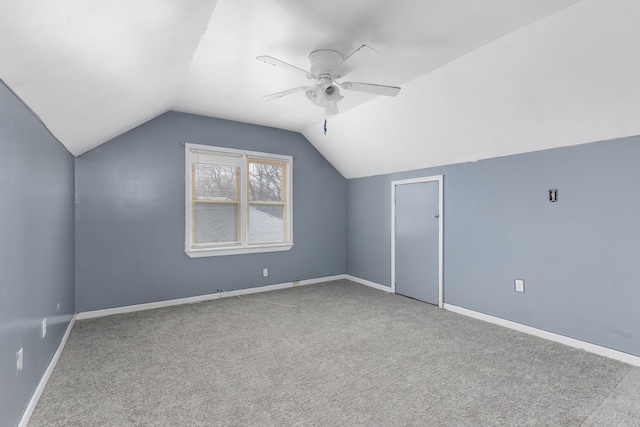 additional living space with ceiling fan, vaulted ceiling, and carpet