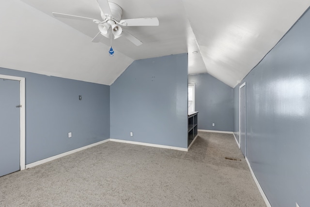 additional living space featuring ceiling fan, carpet, and vaulted ceiling